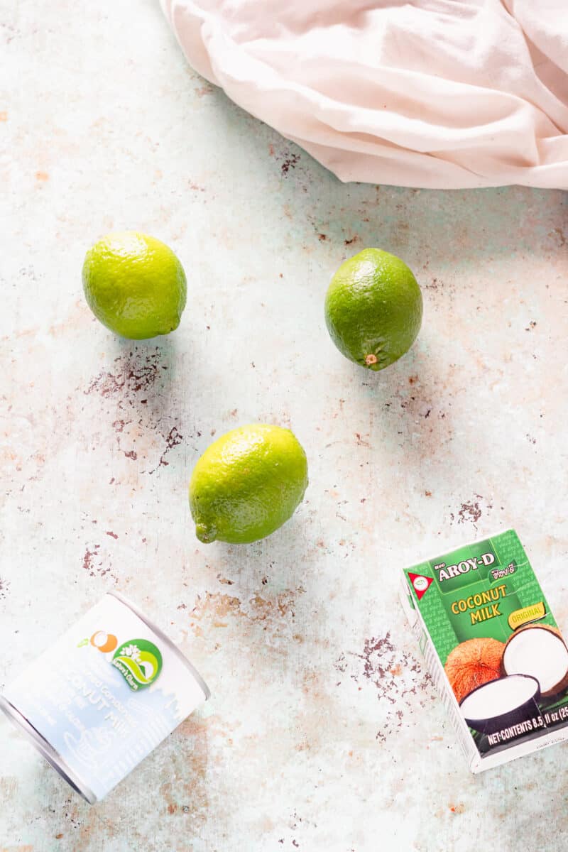 Limes, coconut milk, and a jar of sweetened condensed coconut milk