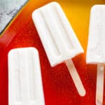 Coconut Lime Popsicles on red and yellow tray