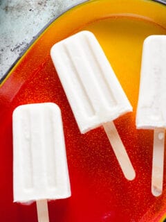 Coconut Lime Popsicles on red and yellow tray