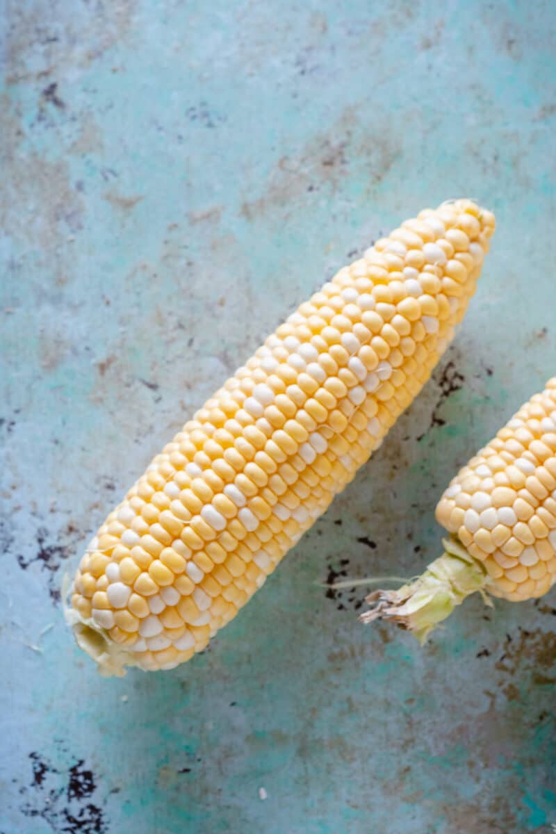 Ear of sweet corn, shucked, on a counter top