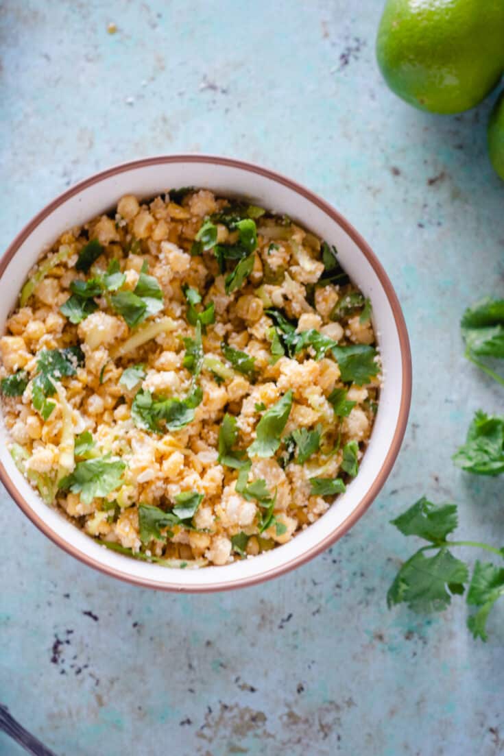 Corn with Miso Lime Butter in a white bowl, overhead shot, close up