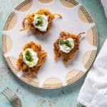 Curried Sweet Potato Latkes with Yogurt and Cilantro-Mint Chutney on a plate