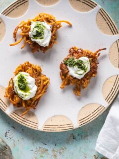 Curried Sweet Potato Latkes with Yogurt and Cilantro-Mint Chutney on a plate