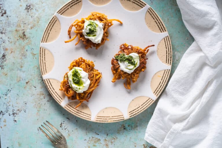 Curried Sweet Potato Latkes with Yogurt and Cilantro-Mint Chutney on a plate