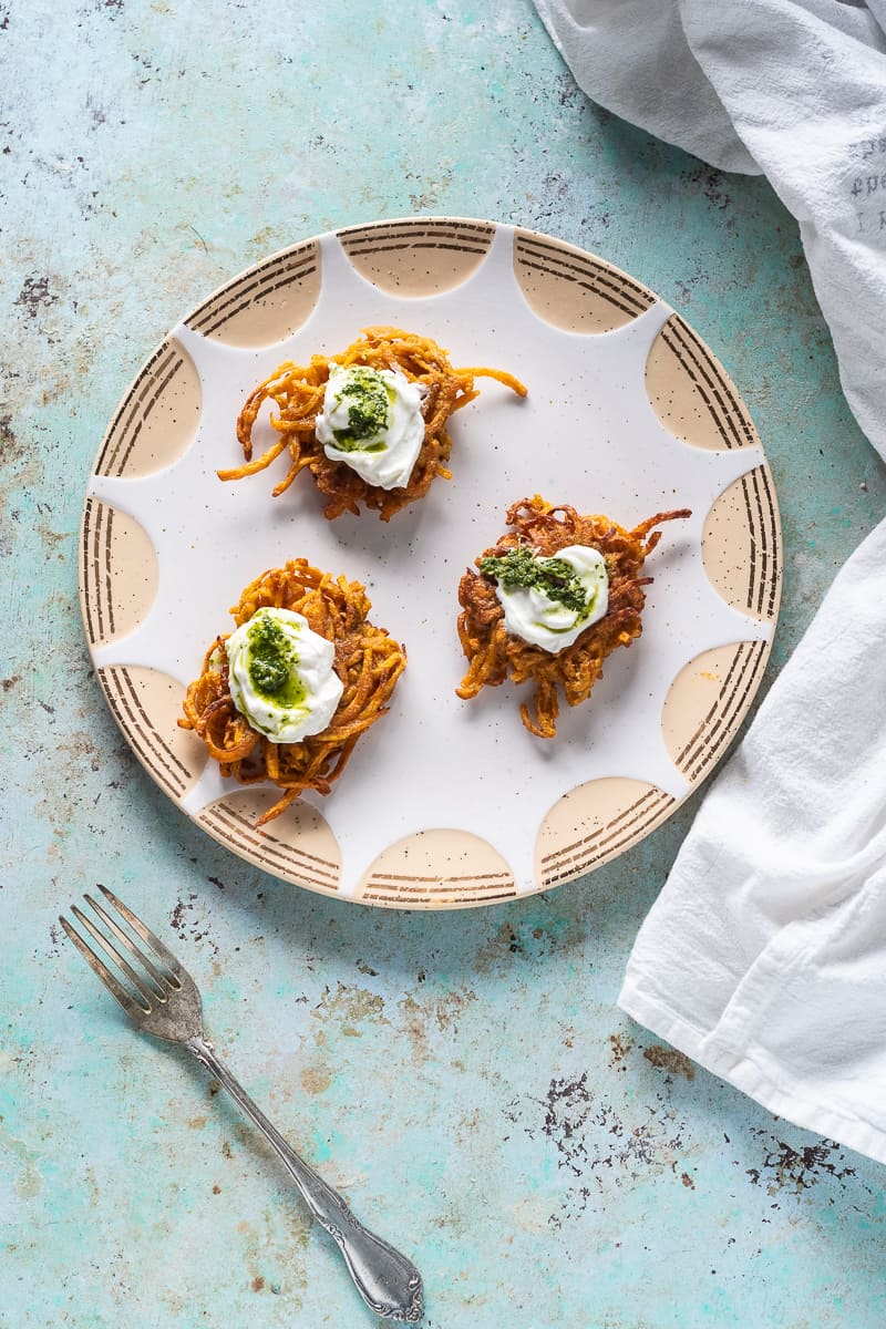 Curried Sweet Potato Latkes on a plate, far away