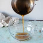 Pouring brown butter into a bowl from a saucepan