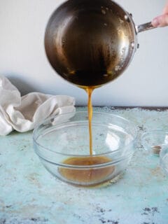 Pouring brown butter into a bowl from a saucepan