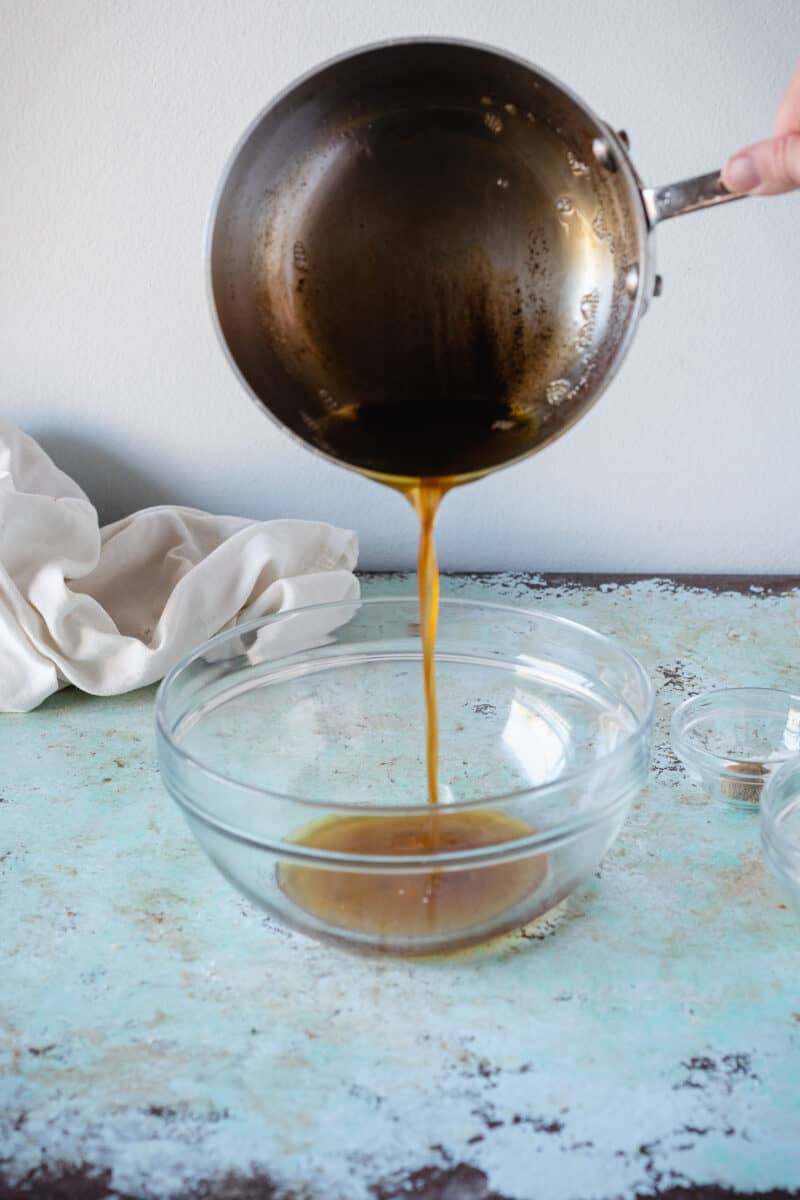 Pouring brown butter into a bowl from a saucepan