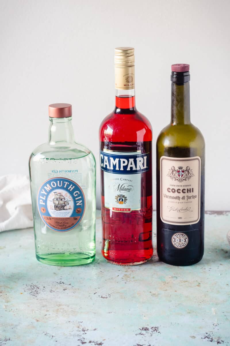 Bottles of Plymouth Gin, Campari, and Cocchi di Torino Sweet Vermouth