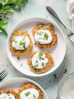 Zucchini fritters with yogurt and mint on a plate