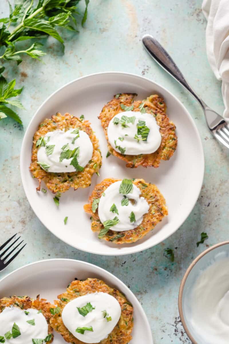 Zucchini fritters with yogurt and mint on a plate