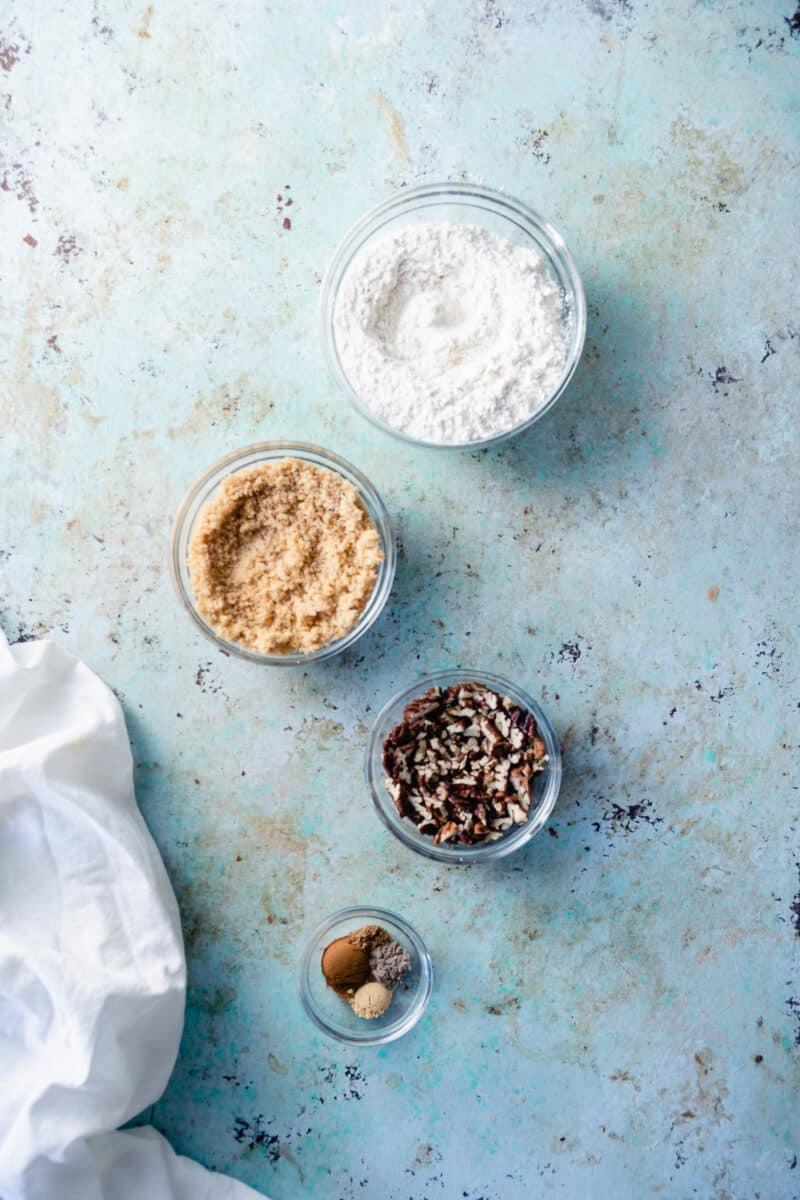 Flour, brown sugar, pecans, spices in separate glass mixing bowls