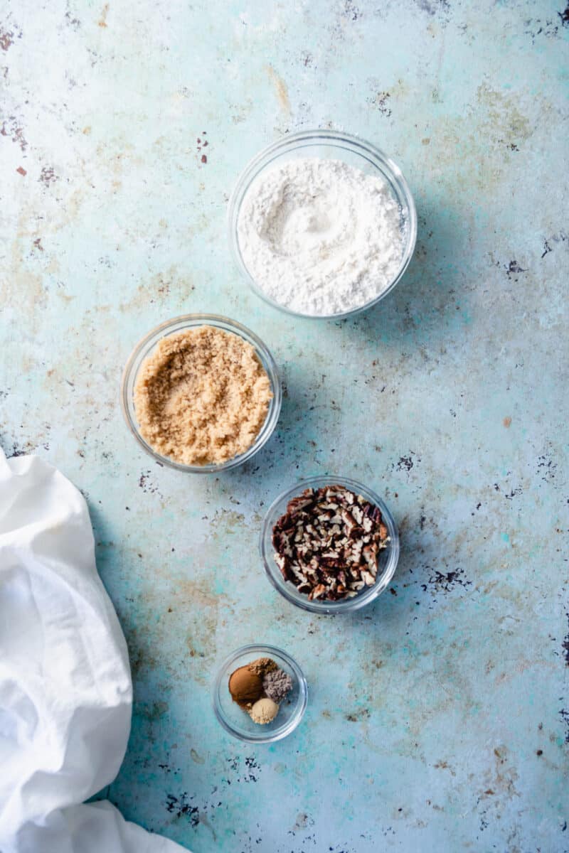 Flour, brown sugar, pecans, spices in separate glass mixing  bowls