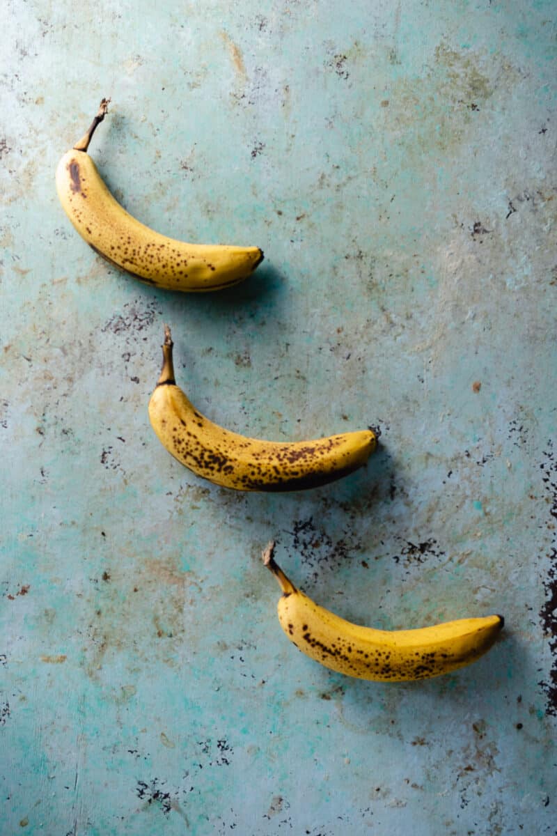 Three bananas on a counter