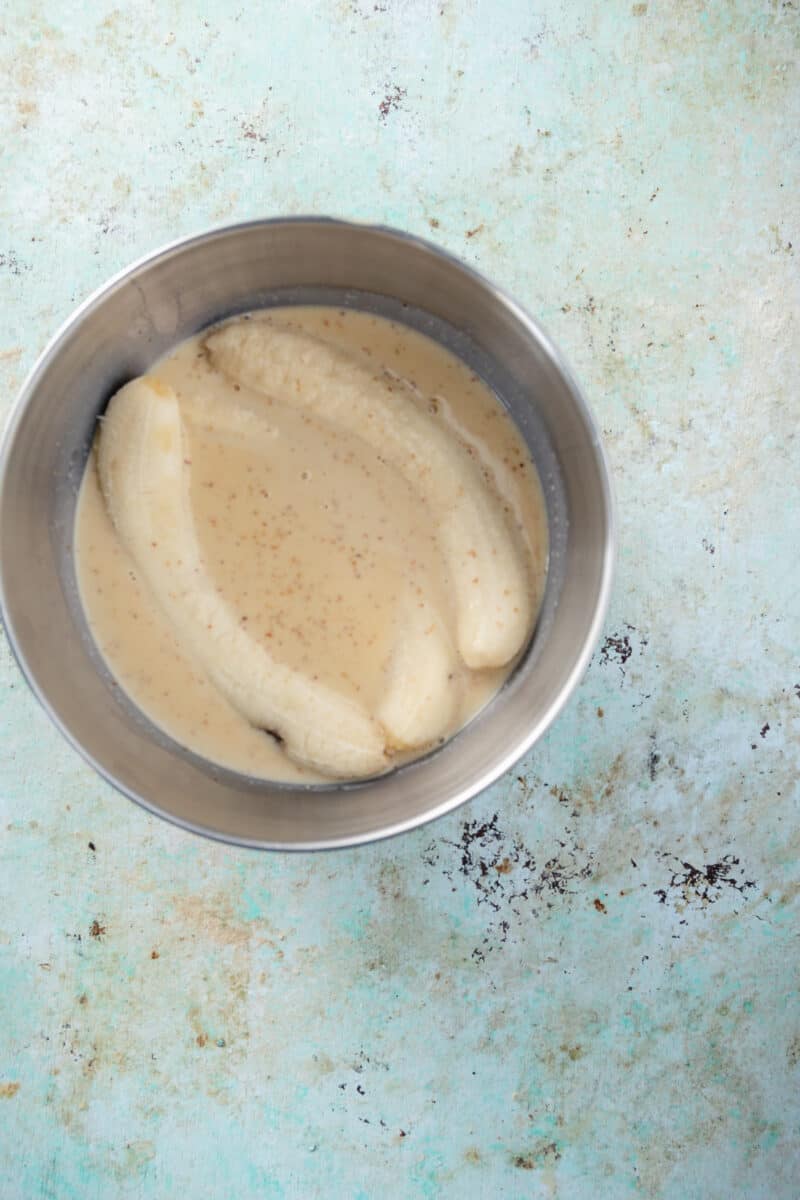 Bananas steeping in cream and sugar mixture