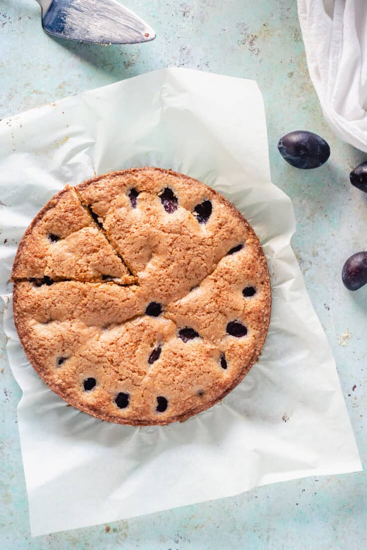 Almond anise plum torte with one slice cut