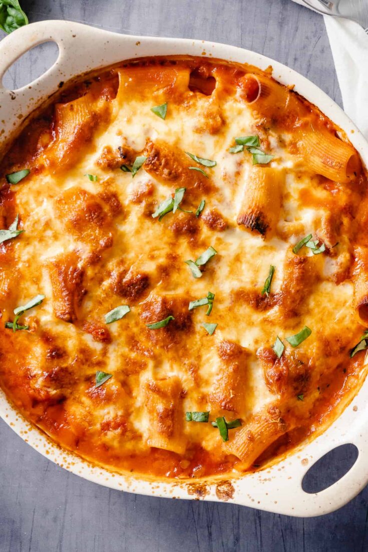 Baked Ziti in an off-white baking dish, close up