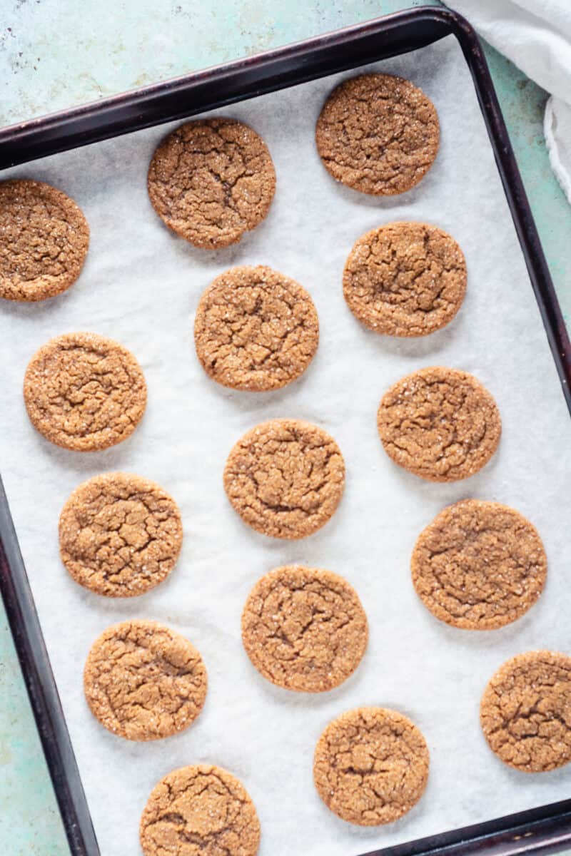 Chewy Citrus Molasses Spice Cookies on a sheet pan