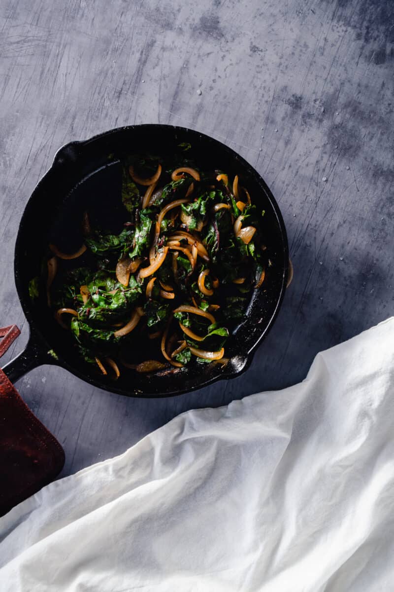 Chard and onions in a cast iron skillet