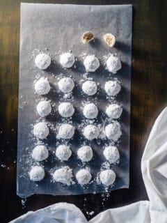 Mexican Wedding Cookies lined up on a sheet of wax paper