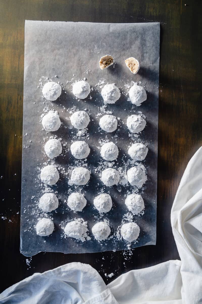 Mexican Wedding Cookies lined up on a sheet of wax paper