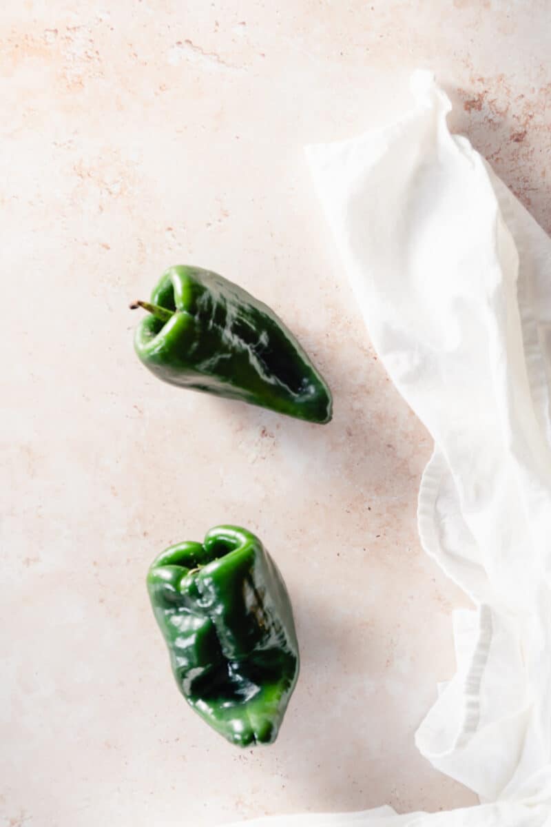 Two poblano peppers on a counter