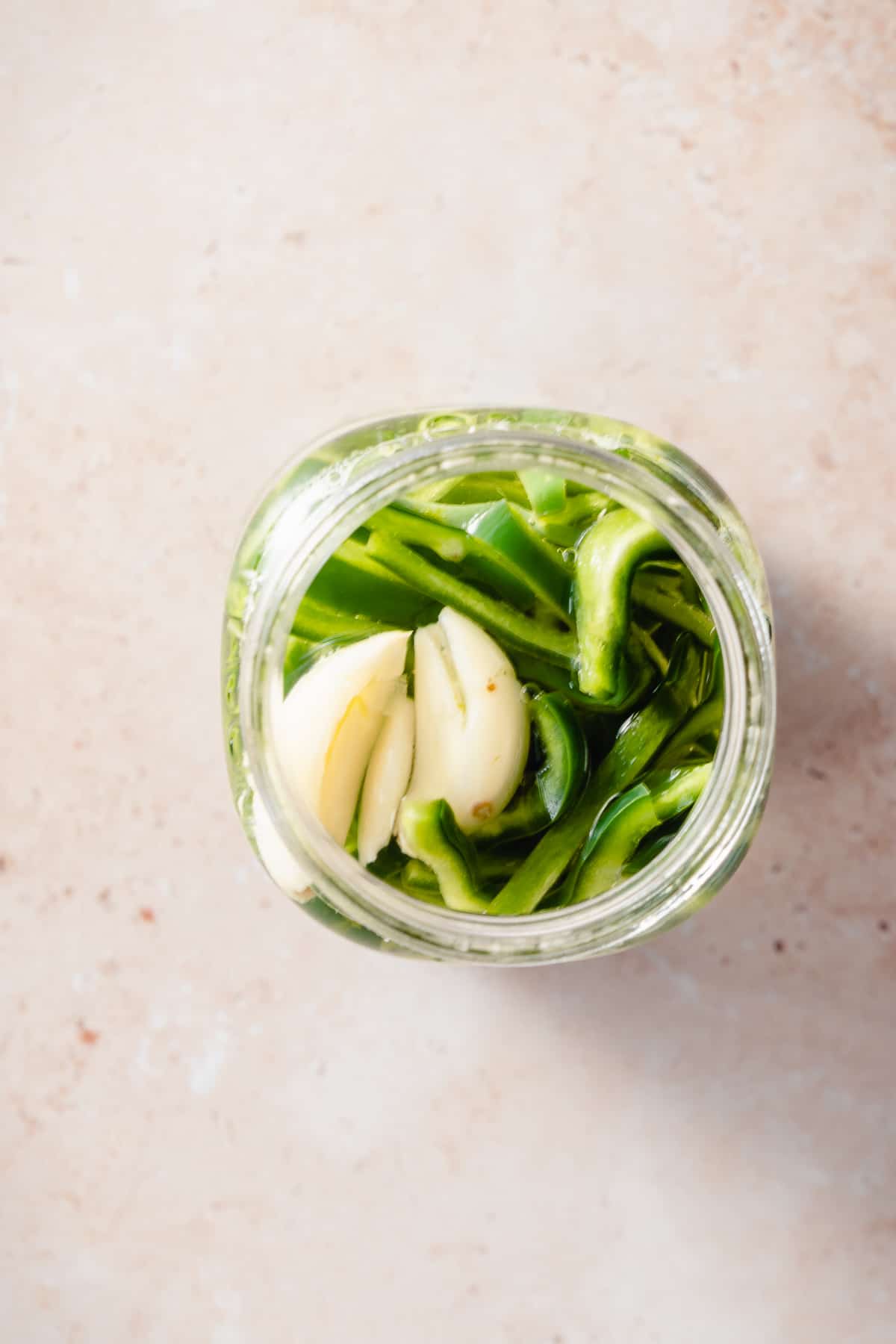 Quick pickled poblano peppers in a mason jar overhead view