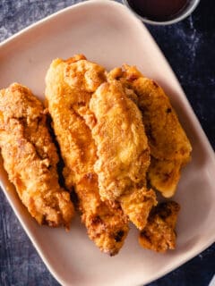 Crispy Chicken Tenders on a pink plate