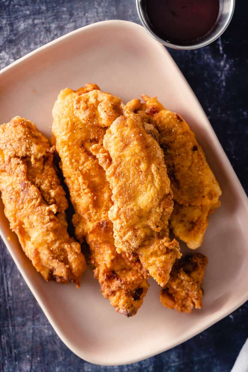 Crispy Chicken Tenders on a pink plate