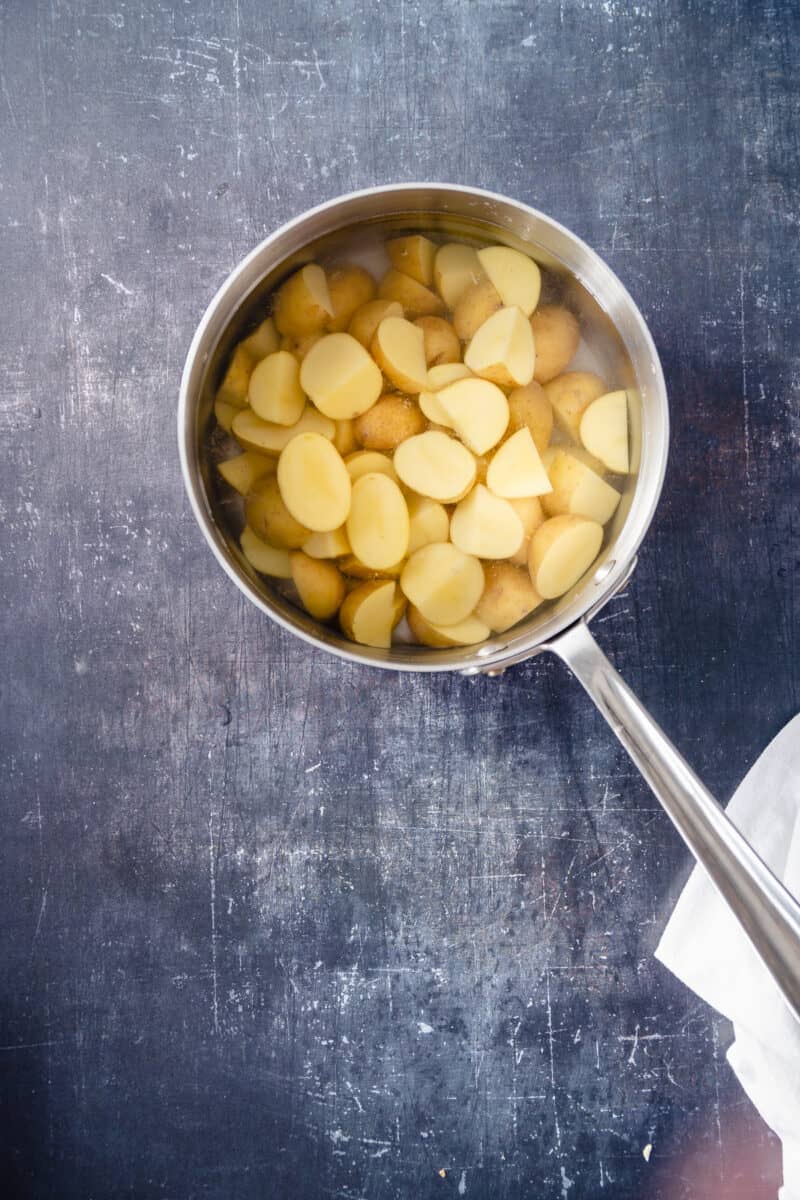 Sliced potatoes in salted water in a pot