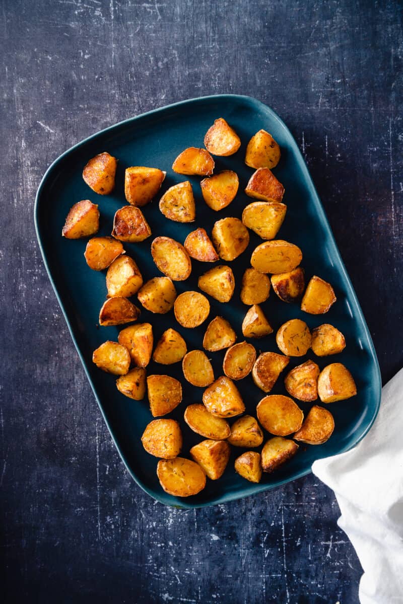 Crispy potatoes on a blue tray