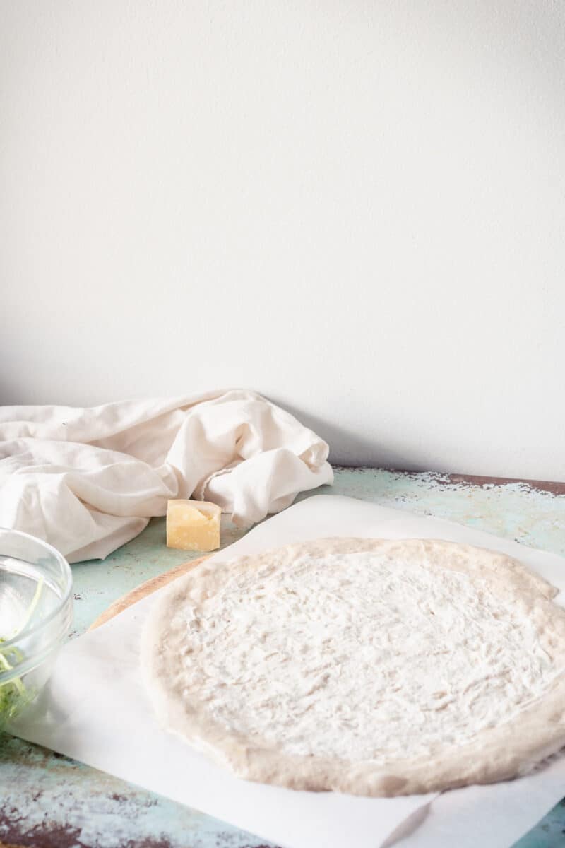 Pizza dough with a thin layer of creme fraiche