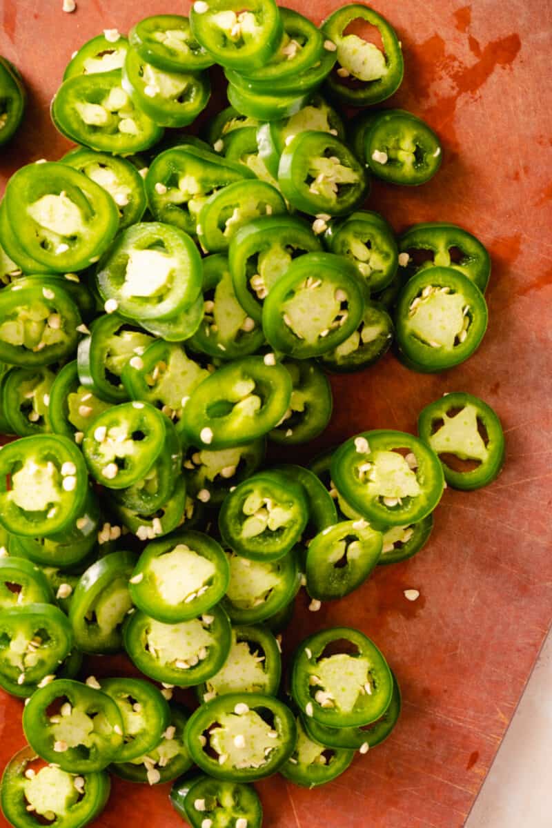 Sliced jalapeño peppers on a cutting board