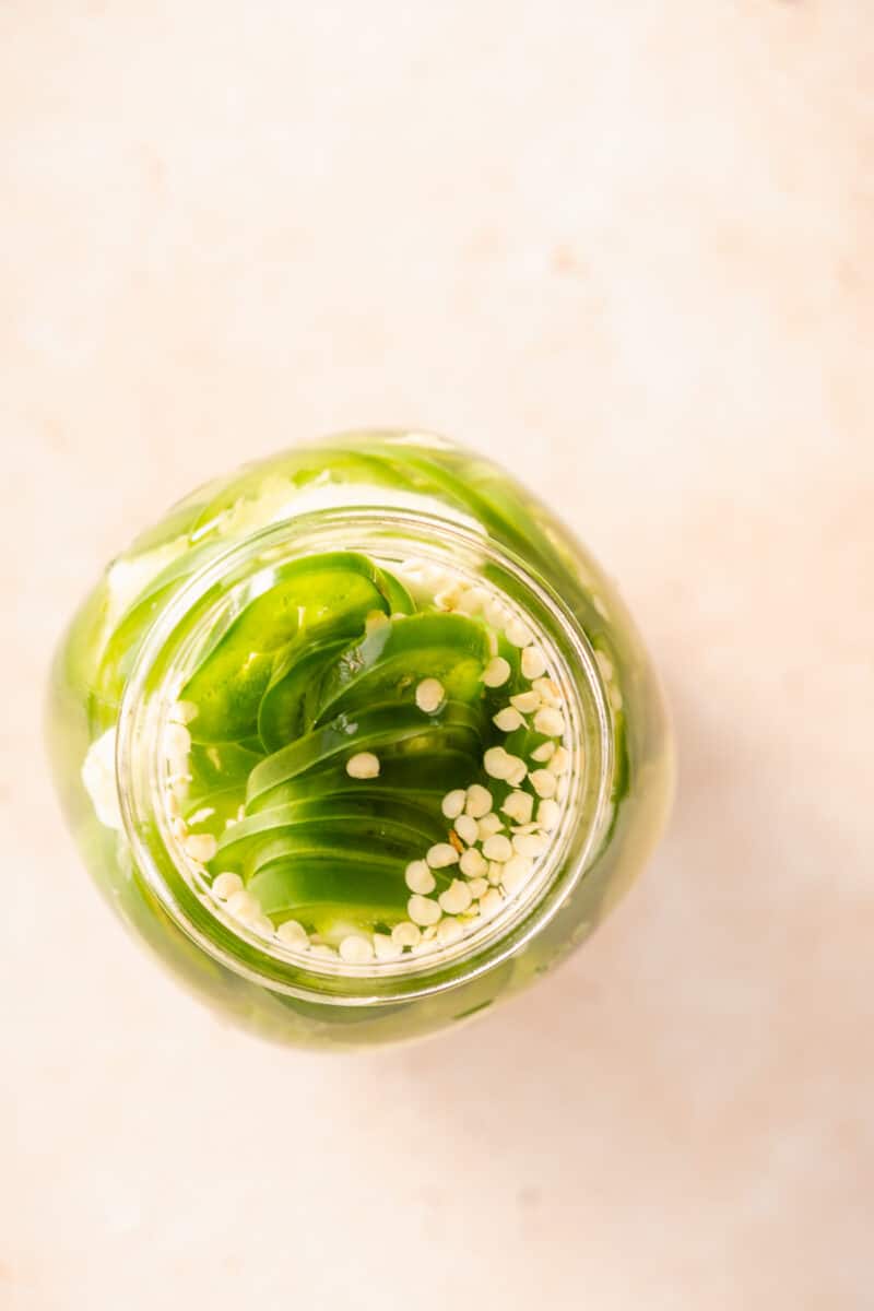 Pickled jalapeños in a jar, overhead view