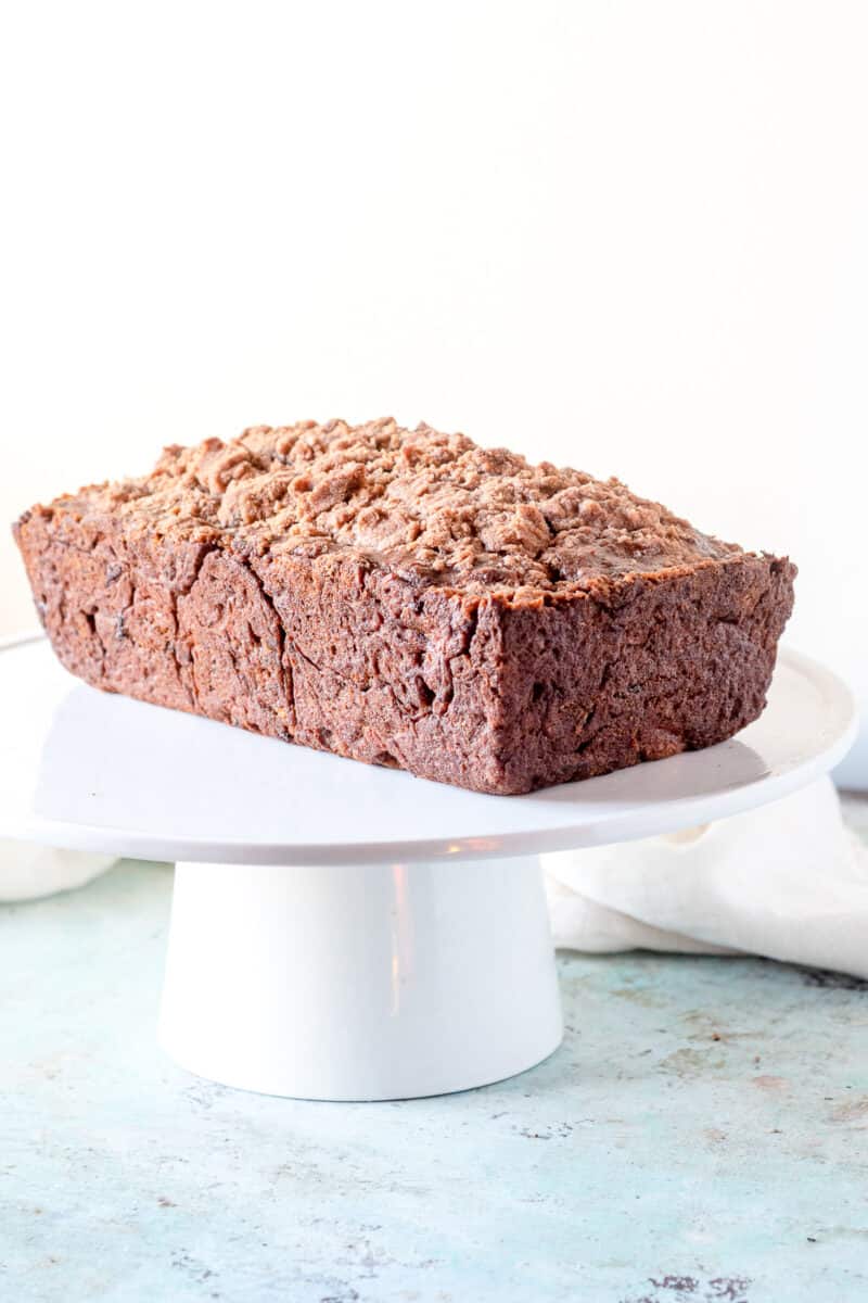 Streusel-topped Banana Bread on a cake stand, side view