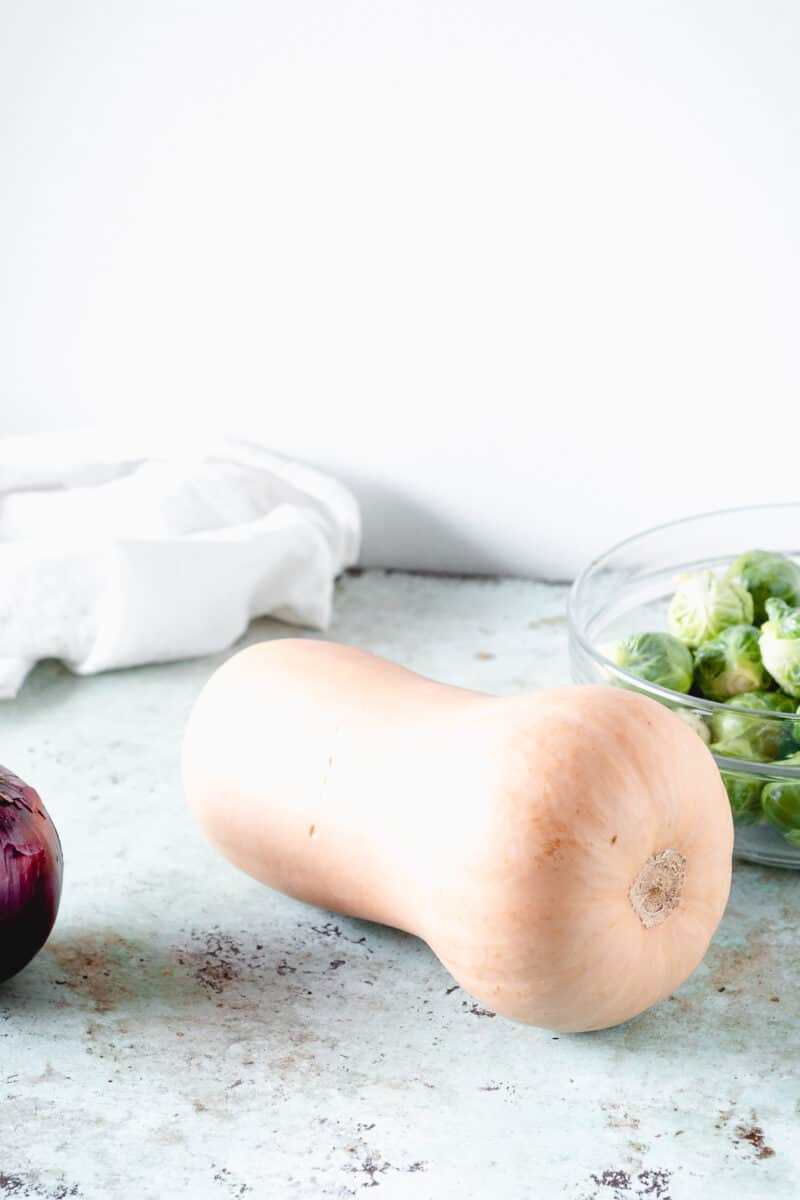 Red onion, butternut squash, Brussels sprouts in a bowl