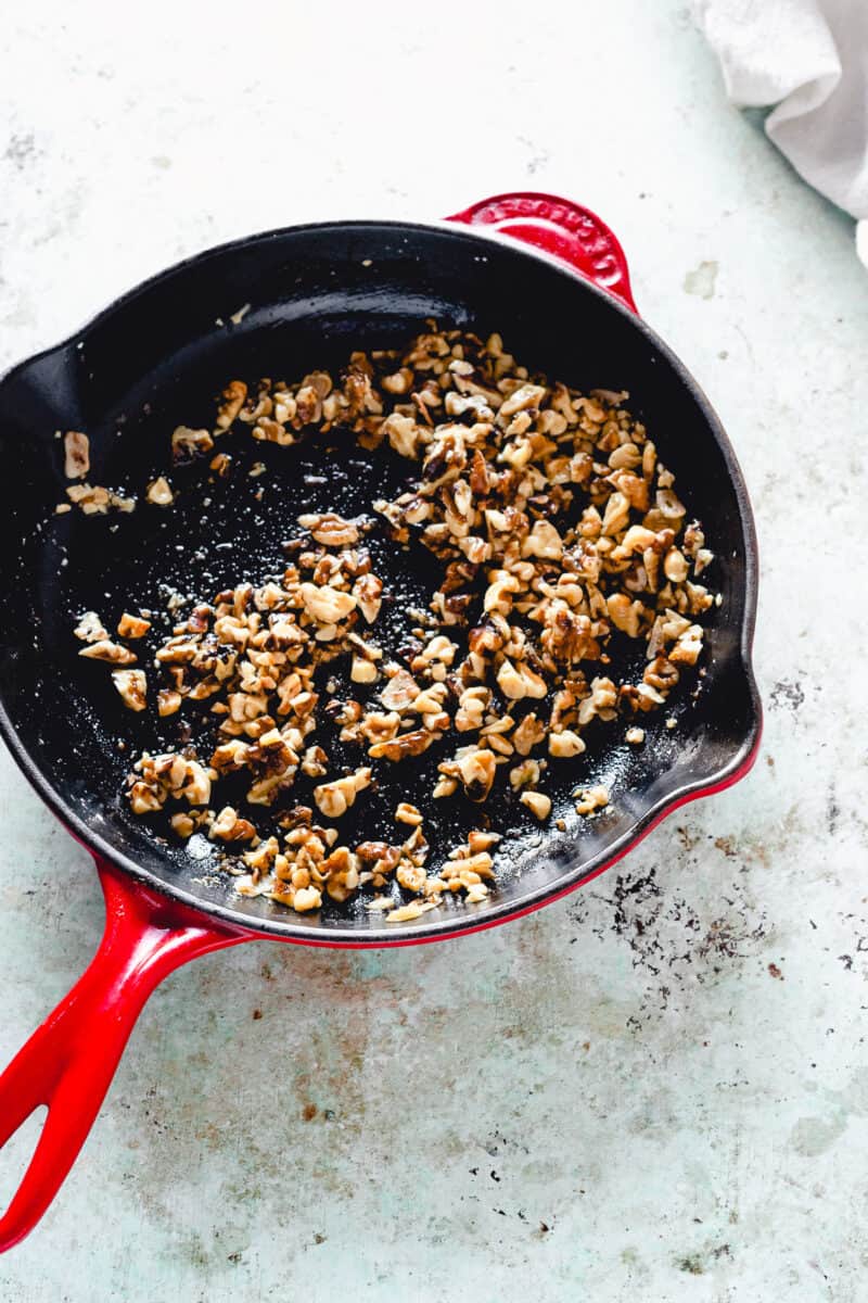 Walnuts, garlic, red pepper flakes, and olive oil in a skillet