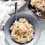 Ricotta walnut pasta in a gray pasta bowl with a pan of pasta alongside