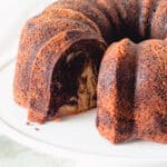 Chocolate Orange Olive Oil Bundt cake on a white cake stand