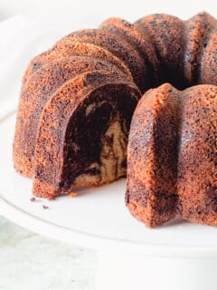 Chocolate Orange Olive Oil Bundt cake on a white cake stand