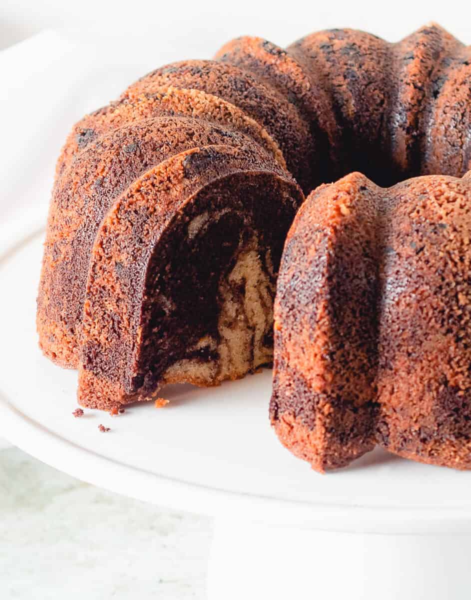 Chocolate Orange Olive Oil Bundt cake on a white cake stand